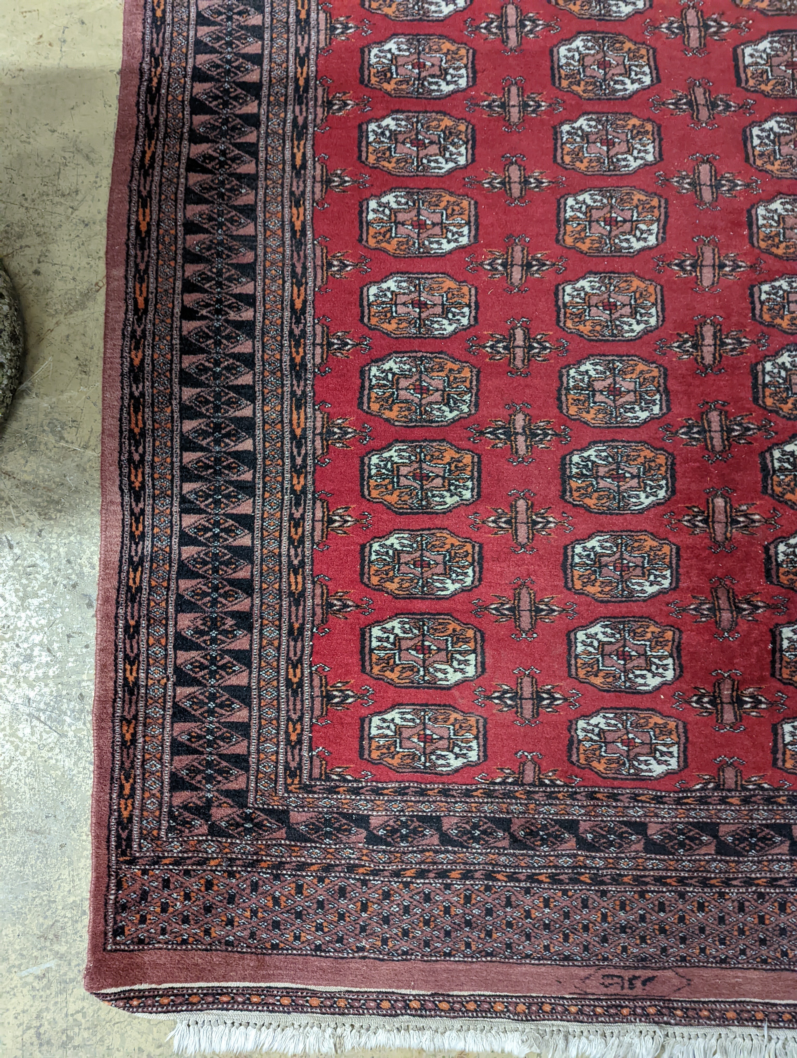 A Bokhara red ground rug, 196 x 126cm